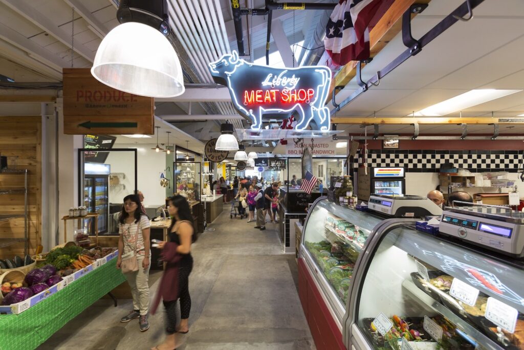 Interior of Liberty Station Market featuring a sign stating "Liberty Meat Shop" in the shape of a cow