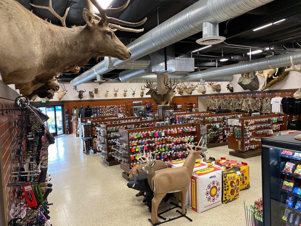 Performance Archery Mira Mesa San Diego store featuring bows, arrows, targets, and mounted deers inside