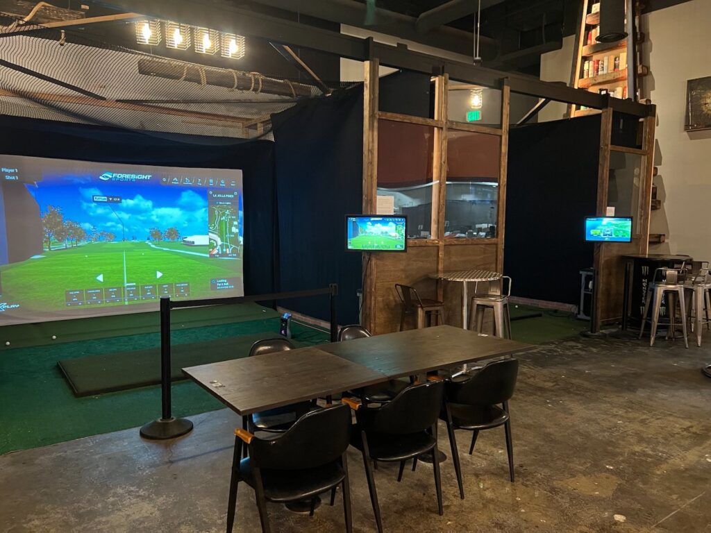Golf simulation machines at The Hive in the Convoy District